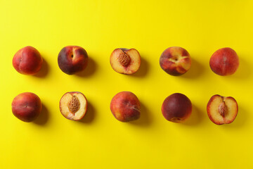 Fresh ripe peach fruits on yellow background