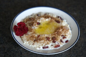 ready to eat, rice pudding with melted butter, sugar and cinnamon and raisins