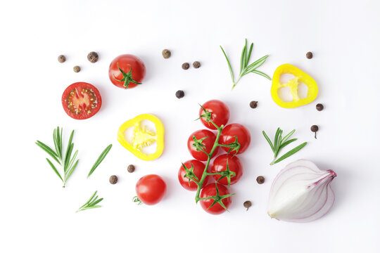 Composition of fresh ripe tomatoes of different varieties, mini bell peppers, onions, rammarine, basil and spices as a background close-up