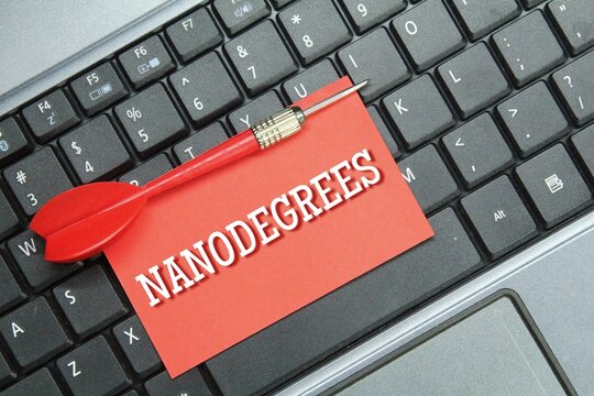laptop keyboard, colored paper with the word nanodegrees