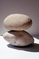 Balancing stones. Stones for spa treatments on a white background. The concept of meditation on the stones is stacked in a pyramid.