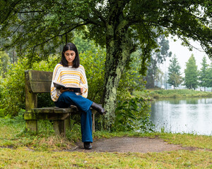 Girl reading a book in the park