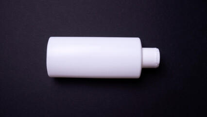 shampoo or hair conditioner bottle isolated on black background