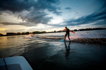 Young man enjoys wake-boarding