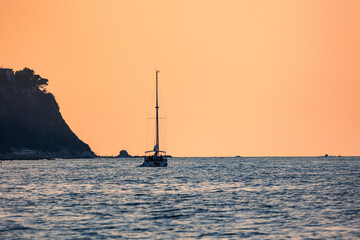Sailing ship with raised sails laying for anchor near the coast of Ancona Italy