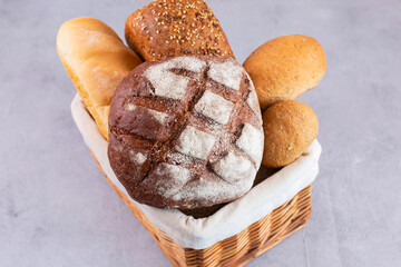 Different kinds of fresh homemade bread in a basket.