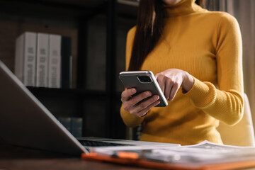 Business people working in the work area with smartphones and data sheets at the desk.