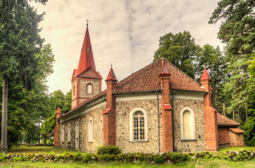 Fototapeta na wymiar Lutheran church, made of stones ar red bricks, Rinda, Latvia.