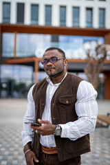 Obraz premium Handsome office manager preparing to speaking on mobile phone outdoor. Looking confident and preparing to important conversation. Serious man wearing stylish formal clothes