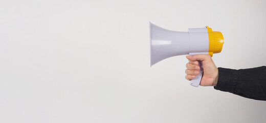 Megaphone in Male Hand and he wear black shirt on white background. Studio shooting.