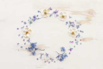 Top view image of Hydrangea flowers composition over white wooden background .Flat lay