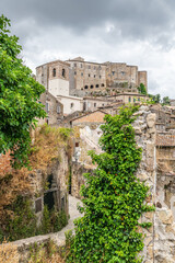 picturesque view of Sorano with old staircase, alley, underpass and plants in the Tuscan medieval village