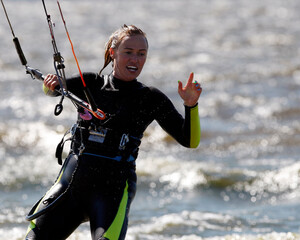 Kiter girl performs a trick