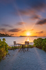 Fototapeta na wymiar Outdoor restaurant with views of ocean and beautiful sky at sunrise. Crossroads Maldives, saii lagoon. Long exposure picture. July 2021