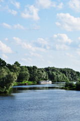 Panoramic view of the river. River and pleasure ship. Summer sunny day.