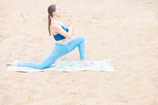 image of woman yoga sand