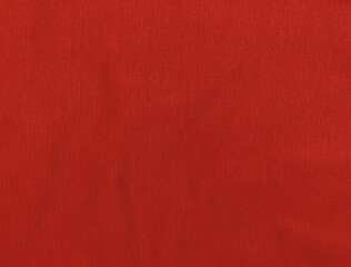Red jersey fabric matte texture top view. Vinous knitwear background. Fashion color trendy clothes....