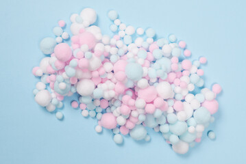 White, pink and blue soft pompons as a background.
