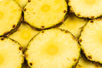 Pineapple juicy yellow slices background. Top view.