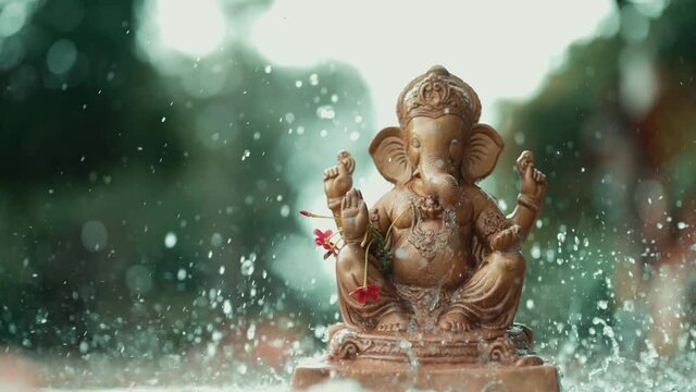 Water splash on lord ganesha sculpture. celebrate lord ganesha festival. 