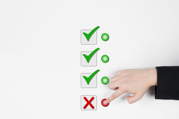 Businessman's hand selects a cross after check mark option on white background. The concept of refusal, wrong answer, or right decision. with free space for copying, business design