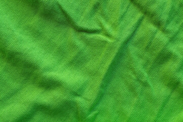 background green wrinkled fabric close-up overhead light