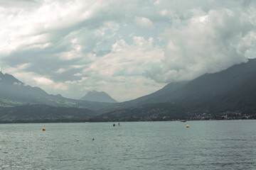View of the mountains and lake Annecy in Haute-Savoie in France in cloudy weather in summer. Water landscape. 