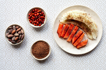 Fresh fruit snack with spicy chili and cocoa condiment powder.