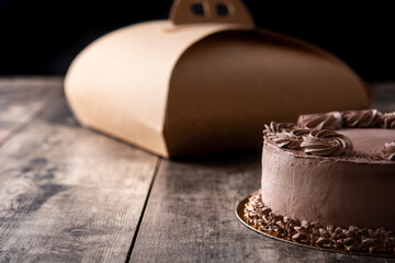 Piece of chocolate truffle cake on wooden table. Copy space