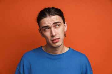 Fototapeta premium Portrait of a pensive confused young white casual man
