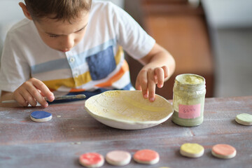 workshop for kids. Children learning how to use clay for making beautiful dishes. Workshop, master class.