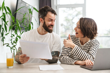 Young white couple working together with laptop