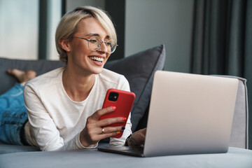 Smiling mid aged blonde woman using mobile phone