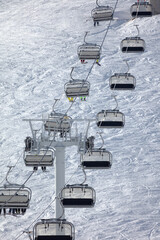 ski lift at a ski resort high in the mountains. chairlift for skiers and snowboarders. high-quality...
