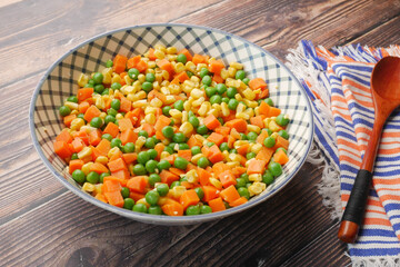 close up of corn, carrot and beans in a bowl,