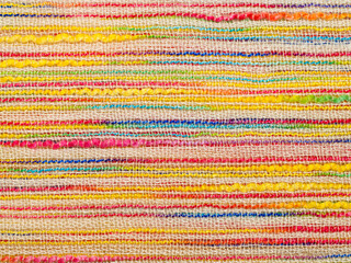 Multicolor striped bouclé cloth background, close-up