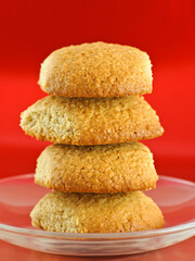 Stack of homemade oatmeal cookies on red background