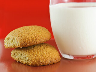 Homemade oatmeal cookies and glass cup of milk