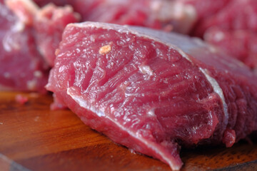 close up of raw meat on chopping board on a chopping board 