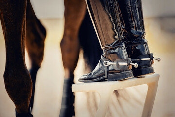 The rider gets on the horse. Equestrian sport. The legs of a rider and a horse.