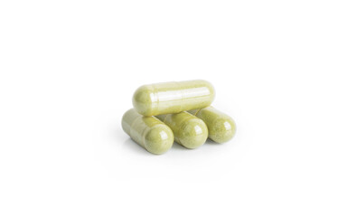Andrographis paniculata pill capsule in green on white background with clipping path and copy space. Alternative medical from herb for treatment corona virus or covid19. Drug and medicine concept.