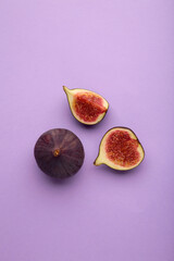 Fresh ripe figs on purple background. Tropical fruit