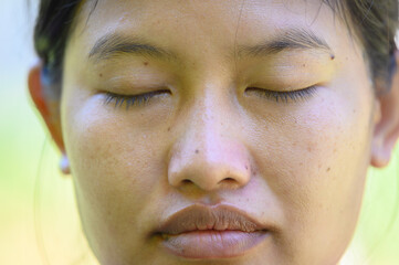 Asian women close one's eyes