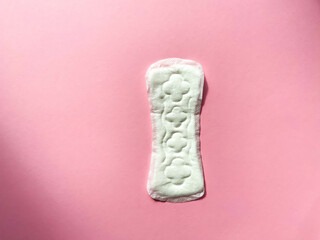 Critical days. Woman hygienic protection, menstruation, cotton tampons, sanitary pads. Feminine hygiene panty liner for menstruation. Menstrual cycle, pad. Pink colorful background. Top view, layout