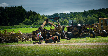 Canandaigua NY Steam Engine Association Pageant of Steam on Saturday, Aug 14, 2021. Young Boy Drives family around looking at Heavy Equipment. Upstate NY.