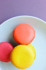 colorful macaroons on a plate, grey table