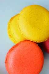 macaroons on a blue background, yellow and orange