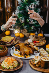 Fototapeta na wymiar festive New Year's table with delicious dishes in the Soviet style, olives, baked meat, lard, champagne