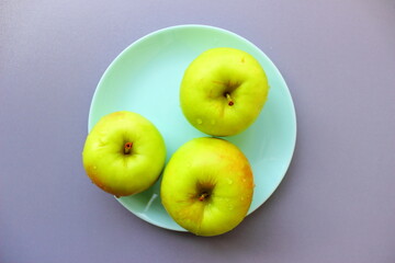 green apples on a blue plate