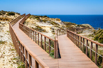 Obraz premium Wooden walkways by the Atlantic Ocean in Zambujeira Do Mar, Alentejo, Portugal